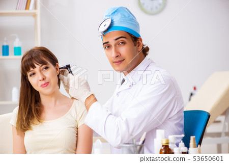 Young woman visting male doctor otolaryngologist 53650601