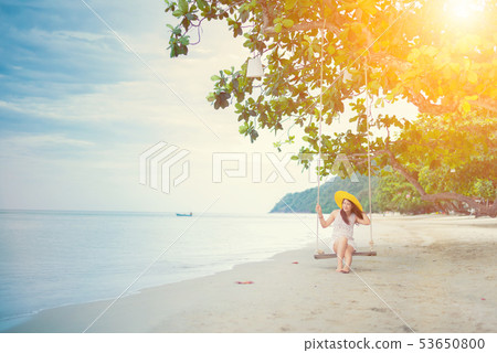 Beautiful Asian women travel at the beach on 53650800