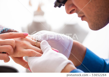 Young jeweler working in his workshop Young jeweler working in his workshop 53652264