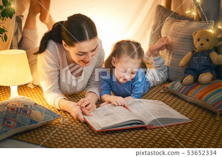 Mom and child reading a book Mom and child reading a book 53652334