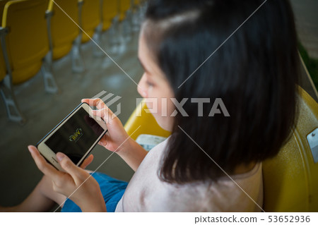 Woman playing ROV online computer game smartphone. 53652936