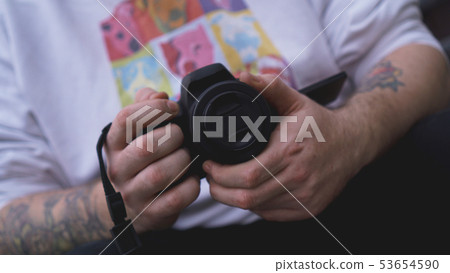 Man photographer holds camera. Photographer concept Man photographer holds camera. Photographer concept 53654590