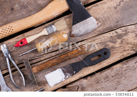 Various tools on a wooden background. 53654811
