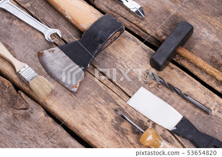 Various tools on rustic wooden planks. 53654820