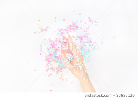 Pearl pastel confetti sparkles with woman hand Pearl pastel confetti sparkles with woman hand 53655126