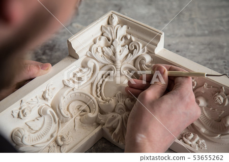 The sculptor creates a bas-relief. Plaster workshop. Close up. Selective focus. The sculptor creates a bas-relief. Plaster workshop. Close up. Selective focus. 53655262