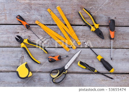 Kit of construction tools and instruments on wooden background. Kit of construction tools and instruments on wooden background. 53655474