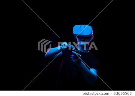 Man with virtual reality headset is playing game. 53655565