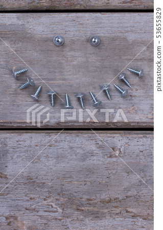 Composition with screws nails on wooden background. 53655829