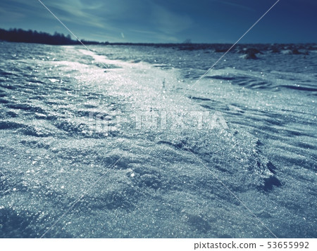 Piece of ice with contour and sun flares Piece of ice with contour and sun flares 53655992