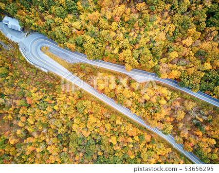 Scenic highway hairpin turn in autumn 53656295