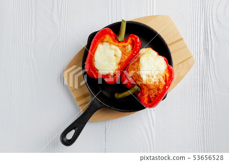 Bell pepper stuffed with meat with melted cheese 53656528