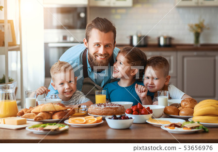 happy family father with children feeds his sons happy family father with children feeds his sons 53656976