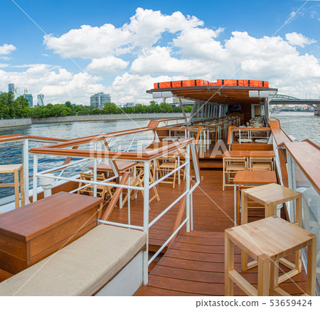 The interior of the urban river ship, with a panoramic view of the urban landscape. The concept of 53659424