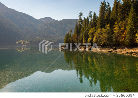 Landscape of Baker Lake water covered with pollen and fallen tree seeds, in North Cascades 53660394
