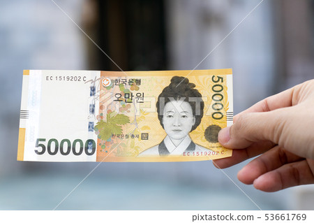 Man hold south korea banknote 50000 won 53661769