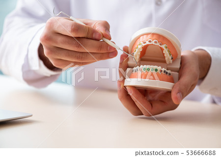 Male doctor stomatologist working in the clinic  53666688