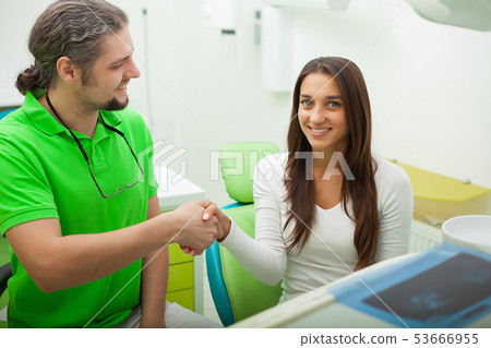 Patient in dentistry. Pretty woman visiting her dentist in clinic 53666955