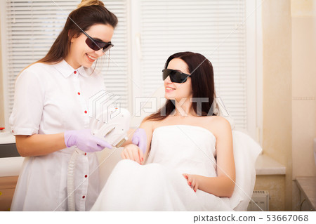 Skin care. Adult woman having laser hair removal in professional beauty salon Skin care. Adult woman having laser hair removal in professional beauty salon 53667068