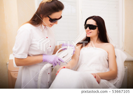 Skin care. Adult woman having laser hair removal in professional beauty salon Skin care. Adult woman having laser hair removal in professional beauty salon 53667105