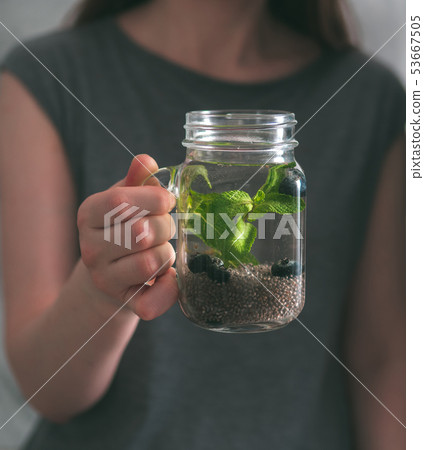 Chia detox water in woman hand 53667505