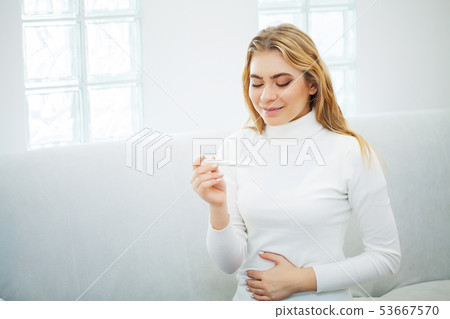 Positive pregnancy test. Portrait young woman holding pregnancy test stick 53667570