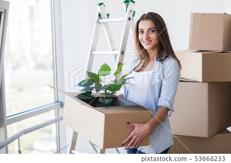 Happy Young Adult Woman Holding Moving Boxes In Empty Room In A New House 53668233