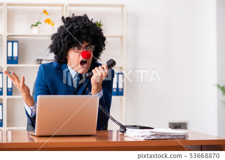 Young clown businessman working in the office Young clown businessman working in the office 53668870