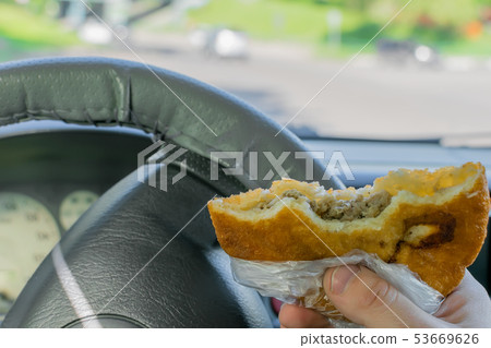 pie, belyash in the hand of the driver in the car pie, belyash in the hand of the driver in the car 53669626