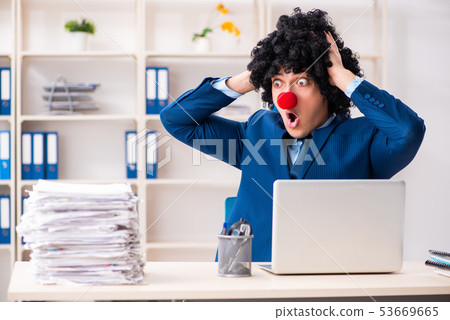 Young clown businessman working in the office Young clown businessman working in the office 53669665