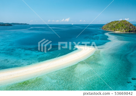 Happy woman standing on a perfect beach 53669842