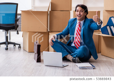 Young handsome businessman moving to new workplace Young handsome businessman moving to new workplace 53669843