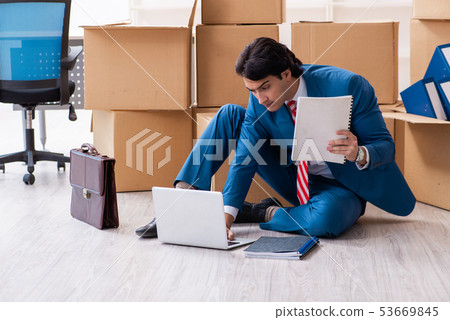 Young handsome businessman moving to new workplace Young handsome businessman moving to new workplace 53669845