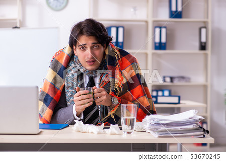 Man with flu working in the office 53670245