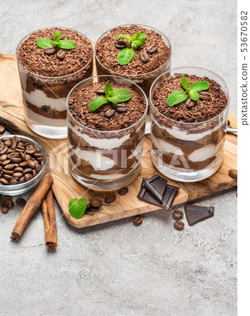 Classic tiramisu dessert in a glass on dark concrete background 53670582