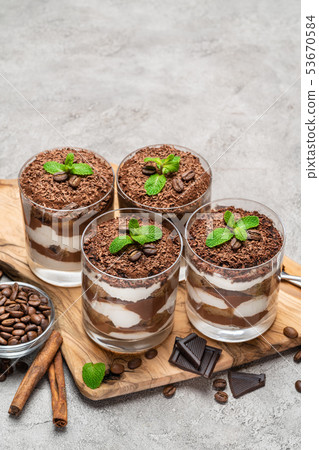 Classic tiramisu dessert in a glass on dark concrete background 53670584