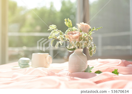 French blue macaroon plate and coffee cup standing on a wooden table with a pink tablecloth white 53670634