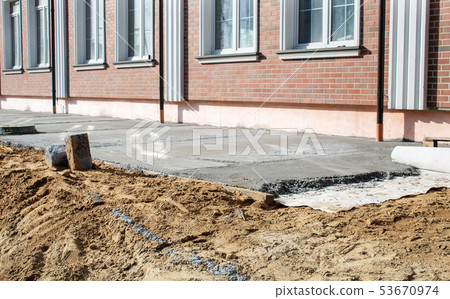concrete pavement near the new building concrete pavement near the new building 53670974