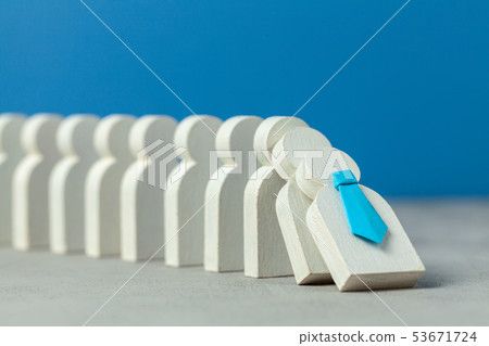 Domino effect in business. One businessman leader falls and brings down other figures of employees. Domino effect in business. One businessman leader falls and brings down other figures of employees. 53671724
