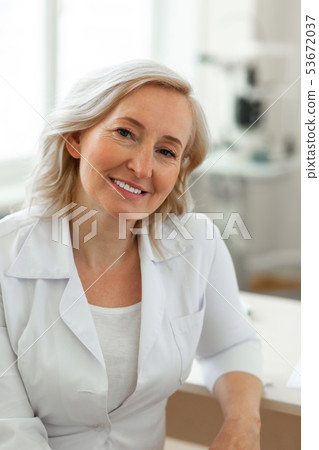 Pleasant blonde lady being experienced doctor and wearing representing robe Pleasant blonde lady being experienced doctor and wearing representing robe 53672037