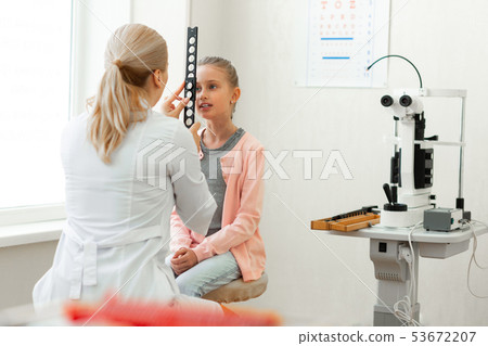 Blonde professional doctor in white robe discovering her new patient 53672207