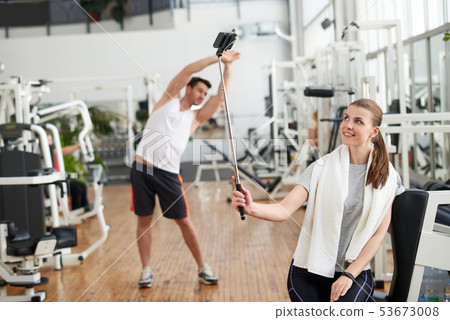 Girl taking selfie at fitness club. 53673008