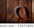 Horseshoe wooden background 53673866