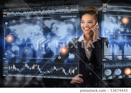 Young business lady speaks on the phone and works in futuristic office Young business lady speaks on the phone and works in futuristic office 53674445