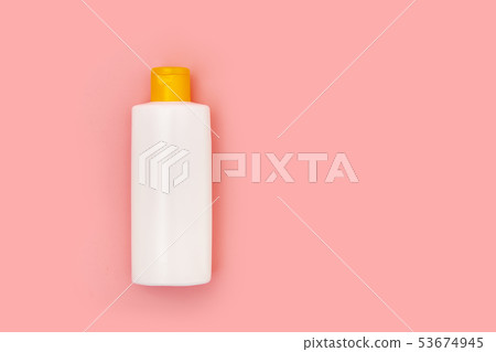 blank white squeeze bottle plastic tube on pink background copy space 53674945