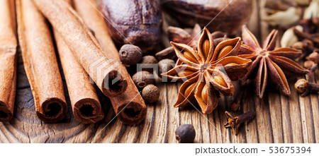 Christmas winter spices and blue pine tree branch on wooden background. Close up. Christmas winter spices and blue pine tree branch on wooden background. Close up. 53675394