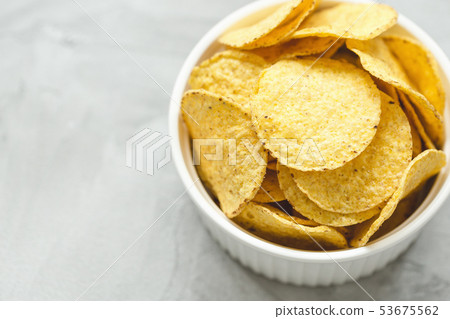 Tortilla corn chips in bowl on a gray background Tortilla corn chips in bowl on a gray background 53675562