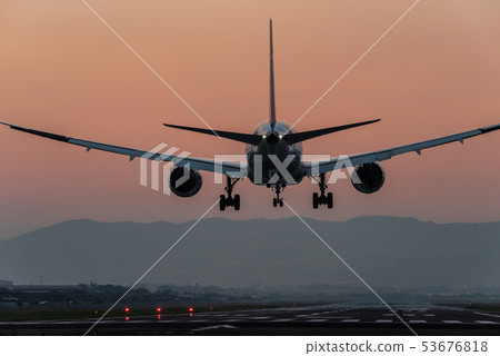 Airplane landing at dusk Airplane landing at dusk 53676818
