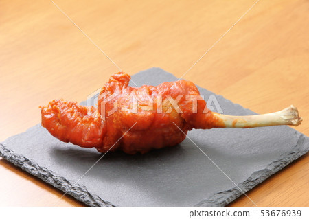 Chicken tulip fried one piece placed on slate plate. 53676939