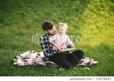 Father and his baby daugter playing in a park Father and his baby daugter playing in a park 53678645